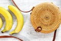 Top view bamboo bag bananas white wooden background Summer fashion holiday