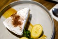 Top view of Banana Banoffee pie with bananas slice and peppermint leaves on gray ceramic plate