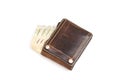 Top view of banknote with old brown leather wallet isolated on white background. Royalty Free Stock Photo
