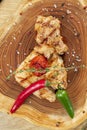 Top view on Barbecue Pork Chop with hot pepper and tomato on a wooden board. CLose up. Selective focus