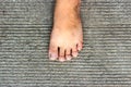 Top View of Bare Foot on Cement Floor Background.