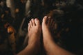 Top view. bare foot of young women has carp fishes in water are