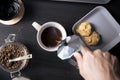 Top view, Barista pouring coffee from moka pot coffee maker to a coffee cup. Hand holding Italian classic moka pot pouring coffee Royalty Free Stock Photo