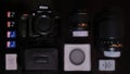 A top view of a basic digital camera kit. Includes SD cards, battery, filter, a pouch camera body and lenses. Royalty Free Stock Photo