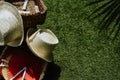 Top view of a basket with paper fans and hats on green grass Royalty Free Stock Photo