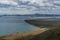 top view of the bay of lake Baikal with islands, peninsulas, clouds, mountains with green trees in sun light