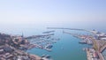 Top view of Bay with yachts near city. Clip. Sea port and Bay with yachts near coast of large tourist city on background