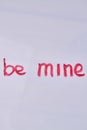 Top view of be mine hand-written love text.