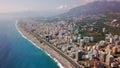 Top view of beautiful big city by sea on background of mountains. Clip. Panorama of southern resort town located on