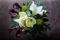 Top view on beautiful bouquet made from white lily, purple calla, and fresh greenery Royalty Free Stock Photo