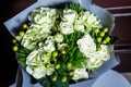 Top view on beautiful luxury bouquet of big white roses and fresh greenery Royalty Free Stock Photo