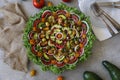Top view of beautiful Mandala like fresh tomato, avocado, olives, lettuce and onion salad garnished with spring onion & nigella se Royalty Free Stock Photo