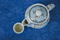 Top view of beautiful porcelain teapot and small cup with tea Royalty Free Stock Photo