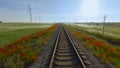 Top view of beautiful railway on background of green field. Shot. Wind farm near beautiful railway in green field