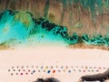 Top view of beautiful sand beach with turquoise ocean water and colorful umbrellas, aerial drone shot Royalty Free Stock Photo