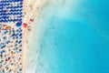 Top view of beautiful sandy beach La Pelosa with turquoise sea water and colorful blue umbrellas Royalty Free Stock Photo