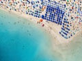 Top view of beautiful sandy beach with turquoise sea water and colorful umbrellas, Islands of Sardinia in Italy Royalty Free Stock Photo