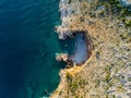 Top view of a beautiful sea harbor. Lagoon with dark blue water. Waves near rocky coast and boat Royalty Free Stock Photo