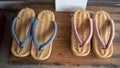 Top view of beautiful two pairs weave shoes on wooden shelf for background