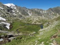 Top view of beautiful wetland with spring stream, alpine mountain meadow called Paradies with lush green grass and snow Royalty Free Stock Photo