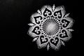 Top view of beautiful white rangoli design on black background with copy space in the left. dipawali concept