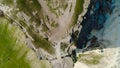 Top view of beautiful white rock with green grass on background of blue sky. Shot. Panorama of white cliff with green