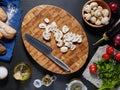 Top view of a beautiful wooden cutting board with chopped mushrooms Royalty Free Stock Photo