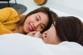 Beautiful young asian women lesbian happy couple hugging and smiling while lying together in bed under blanket at home. Royalty Free Stock Photo