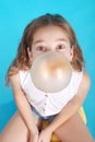 Top view of beautiful young brunette girl blowing bubble gum Royalty Free Stock Photo