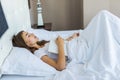 Top view of beautiful peaceful young woman holding book and sleeping in bed Royalty Free Stock Photo