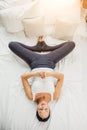 Top view on beautiful young woman lying on bed, in shavasana pose Royalty Free Stock Photo