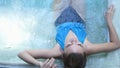 Top of view of beautiful young woman relaxes in a hydromassage jacuzzi, in swimming pool. Concept: spa procedures, body Royalty Free Stock Photo