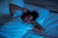 Top View of Beautiful Young Woman Sleeping Cozily on a Bed in His Bedroom at Night. Blue Nightly Colors with Cold Weak Lamppost