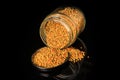 top view on bee pollen grain poured out from glass jar Royalty Free Stock Photo