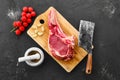 Top view of beef ribeye steak bone-in with spice on black background Royalty Free Stock Photo