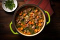 top view of beef stew in cast iron pot, steam visible