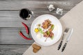 Top view beef tartar of raw minced meat restaurant served on white plate and glass of red wine on table, gray background Royalty Free Stock Photo