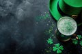 Top view of beer, green shamrock and clover leaves on concrete table,