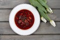 Top view on beetroot soup and fresh white tulips Royalty Free Stock Photo