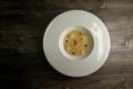 Top view beige seafood cream soup decorated with dried squid and soy sauce