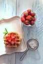 Top view Belgian waffles with strawberries on a plate