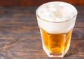 Top view of big glass with a light beer and a large head of foam Royalty Free Stock Photo