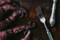 top view of big octopus with fork and knife on rusty Royalty Free Stock Photo