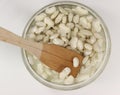 Top view of big white beans soaking in a bowl