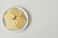 top view of  biscuits on white round ceramic dish placed on beige background with copy space Royalty Free Stock Photo