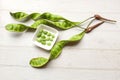 bitter bean, twisted cluster bean, stink bean, sato, petai or pakria,(parkia speciosa) in square white bowl