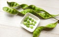 bitter bean, twisted cluster bean, stink bean, sato, petai or pakria,(parkia speciosa) in square white bowl