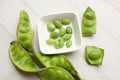 bitter bean, twisted cluster bean, stink bean, sato, petai or pakria,(parkia speciosa) in square white bowl