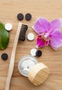 Top view of black activated charcoal and white fluoride toothpaste tablets.