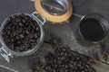 Top view black american coffee in glass with roasted coffee beans in jar on rustic wooden table.Coffee vintage background Royalty Free Stock Photo